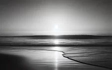 Black and white minimalist beach scene at sunset with gentle waves and a soft horizon, symbolizing calm and introspection. The serene shoreline evokes a sense of balance, peace, and mindfulness, perfect for a blog about starting a meditation practice for holistic health.